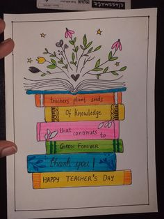 a hand holding up a card with an image of books and flowers on it that says happy teacher's day