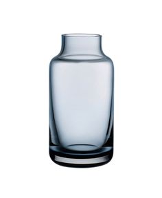 an empty glass vase sitting on top of a white surface with no one around it