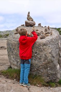 Little boy playing with rocks along the path to Preikestolen Things To Keep In Mind, Keep In Mind, Monument Valley, Read More, Hiking