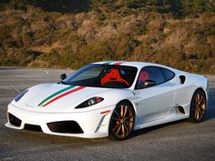 a white sports car with red, green and blue stripes on it's hood