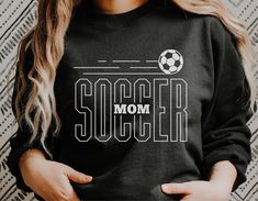 a woman wearing a black soccer mom sweatshirt