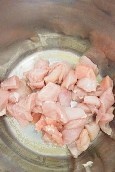 raw meat in a metal bowl being prepared to be cooked