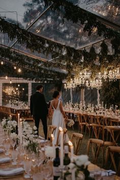 a bride and groom standing at the end of their wedding reception