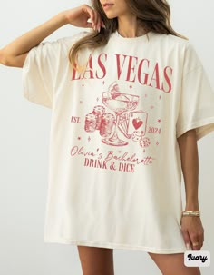 "Comfort Colors Las Vegas Bachelorette Shirt, Retro Casino Bach Club Girls Trip Tee, Personalized Luxury Bachelorette Logo, Modern Poker Dice Bachelorette Party Shirts, Vegas Before Vows, Custom Wedding Shirt, We Said Vegas, Drink and Dice Shirt ✧ WHY  YOU'LL  LOVE IT ✧  ⋒ Comfort Colors® tees are garment-dyed shirts that are timeless classics and will never pile.  ⋒ Trendy retro vintage look and gorgeous colors.  ⋒ Amazingly soft and comfy. Perfect with any shorts, skirts, jeans, leggings, or nothing but undies around the house. ⋒ Created with quality in mind, it's made from 100% ring-spun cotton. ⋒ Will last for years with its double-needle stitched neckline, sleeves, and bottom-hems. ⋒ Garment is made with the most expensive dyeing process, reducing shrinking up to 99%. ⋒Comfort Colors® Vegas Theme Shirts, Las Vegas Bachelorette Shirts, Vegas Before Vows Bachelorette Parties, Las Vegas Wedding Favors, Short Sleeve Tops For Bridesmaids, White Short Sleeve Top For Bridesmaids, Short Sleeve Summer Wedding Tops, Summer Wedding Tops With Short Sleeves, Casino Bachelorette Party