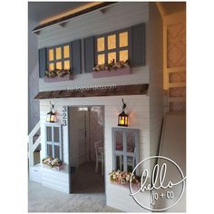 a doll house with windows and lights inside