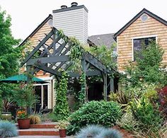 a house with lots of plants in front of it