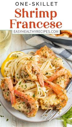 one - skillet shrimp and fettuccine recipe on a plate with lemon wedges