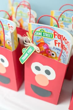 some red bags with sesame street characters on them