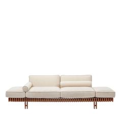 a white couch sitting on top of a wooden frame