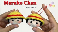 two small crocheted dolls with hats on their heads, one being held by the other