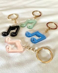 six different colored key chains with music notes on them