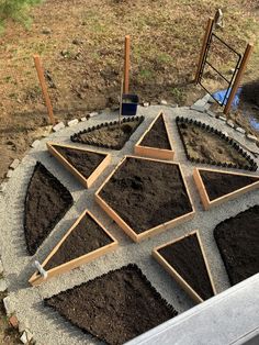 a circular garden with many different types of plants and dirt in the center, surrounded by ladders