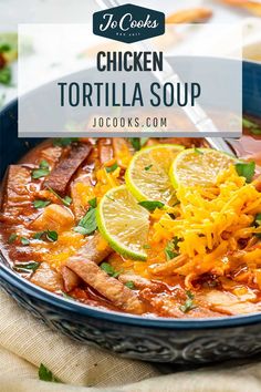 chicken tortilla soup in a blue bowl with lemons and parmesan cheese