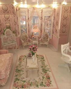 a living room filled with furniture and flowers on the floor in front of a window