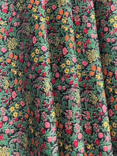 the fabric is very colorful and has flowers on it