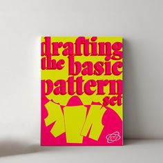 a pink and yellow book with the words drafting the basic pattern set on it's cover