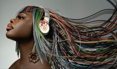 a woman with colorful hair and ear rings