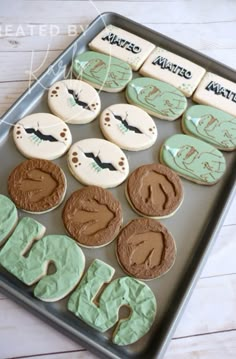 decorated cookies in the shape of letters on a tray