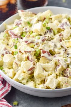 a white bowl filled with potato salad on top of a table