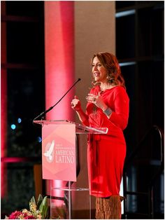 a woman standing at a podium giving a speech