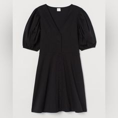 Short, V-Neck Dress In Cotton Jersey. Covered Buttons Full Length Of Front, Short Puff Sleeves With Narrow, Elasticized Cuffs, And Seam At Waist With Gently Flared Skirt. New With Tags. Size Small H&m Black Shirt Dress, Black V-neck Puff Sleeve Dress With Gathered Sleeves, H&m Black V-neck Dress, Black V-neck Puff Sleeve Dress For Work, H&m Black V-neck Mini Dress, Black Puff Sleeve Dress With V-neck For Summer, H&m V-neck Daywear Dress, Black V-neck Mini Dress With Gathered Sleeves, Fitted Black V-neck Dress For Daywear