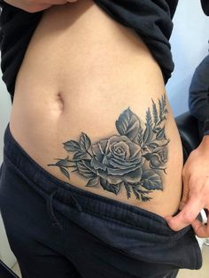 a woman with a rose tattoo on her stomach