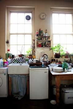 the kitchen is cluttered with pots and pans, dishes, and other things