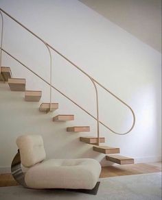 a white chair sitting in front of a stair case