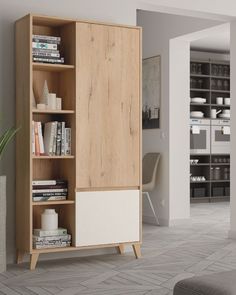 a wooden cabinet with books and magazines on it in a living room next to a couch