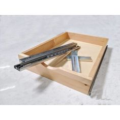 a wooden box filled with tools on top of a white floor