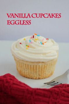 vanilla cupcakes with white frosting and sprinkles on a plate