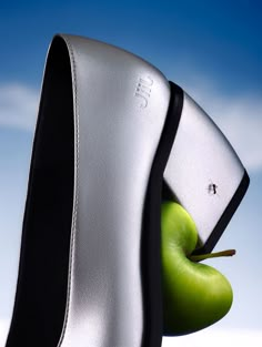 an apple is sticking out of the side of a computer case that's upside down