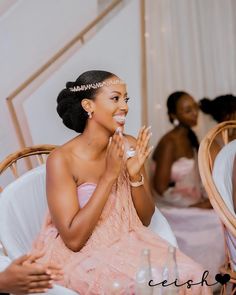 a woman sitting at a table clapping