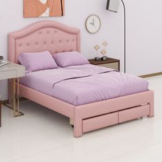 a pink bed sitting in a bedroom next to a white desk and chair with a clock on the wall