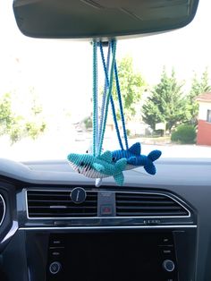 the interior of a car with an air freshener hanging from it's dash board