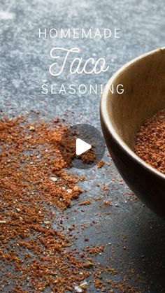 a wooden bowl filled with taco seasoning on top of a table