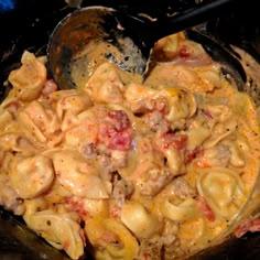 a skillet filled with pasta and meat covered in sauce