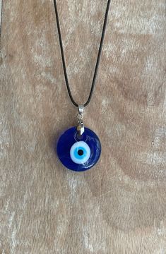 "Free Shipping when you spend $35 at Moondance Trading. Our Products are the same as shown in the pictures. We do not use substitute images. Shapes, sizes, and colors may slightly vary. Everything ships directly from our studio in Orlando, FL. USA Beautiful Handmade Blue Evil Eye Necklace can also be used as wall decor, rearview mirror hang, rearview car mirror decor, car accessory, car decor to bring protection and good luck to you, your loved ones. It has an 18\" vaxed cord and a 2\" chain for Blue Eye Accessories, Jewellery Evil Eye, Eye Of Evil Necklace, Blue Eye Jewelry, Evil Eye Pendant Necklace, Things That Bring Good Luck, Turkish Eye Jewelry, Evil Eye Chains, Evil Eye Jewelry Aesthetic