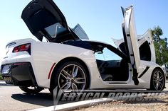 a white sports car with its doors open