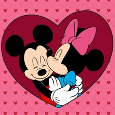 mickey and minnie kissing in front of a heart