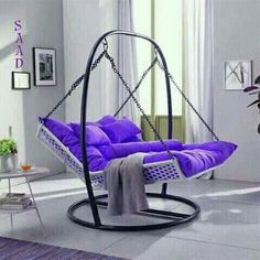 a purple swing chair in a white living room