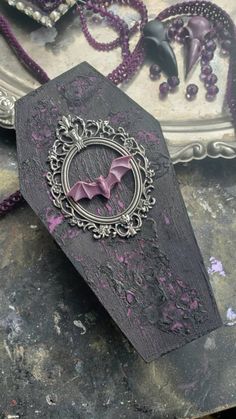 a bat is hanging from the side of a piece of wood with purple paint on it