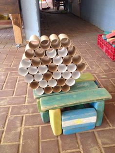 several cups stacked on top of each other in front of a table with stools