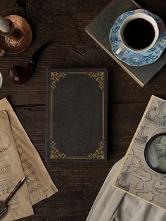 an old book, magnifying glass and some other items on a table with a cup of coffee