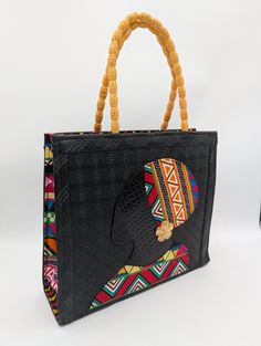 Stand out with our Handmade African Print Tote Bag! This striking Ankara handbag with the silhouette of a beautiful African queen combines tradition with modern style. It was handcrafted by skilled artisans in Ghana, West Africa, using authentic Ankara fabric. Perfect for the fashion-forward woman who values unique, high-quality craftsmanship. Detailed Product Description: * Handmade in Ghana by local artisans, from vibrant, durable Ankara fabric with a bold African print, and faux leather * Features sturdy handles and a spacious interior for all your daily essentials * Lightweight yet strong enough to carry heavier items * Designed with versatility for work, travel, or casual outings Usage and Benefits: * Everyday Use: A perfect tote for work, errands, or weekend getaways * Statement Acce African Print Bags, Woman Purse, Ankara Bags, Black Woman Art, Handmade African, African Queen, Woman Art, Bags Black, Ankara Fabric