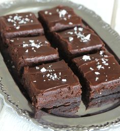 chocolate brownies on a silver platter with sea salt sprinkled on top