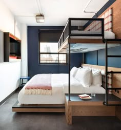 a bedroom with bunk beds in it and a desk next to the bed that's built into the wall