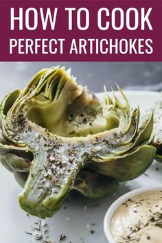 artichokes on a plate with dipping sauce in the middle and text overlay how to cook perfect artichokes