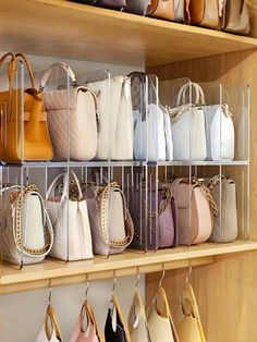 the shelves are filled with many purses and handbags in different colors, shapes and sizes