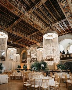 an ornately decorated banquet hall with chandeliers and tables set for formal function